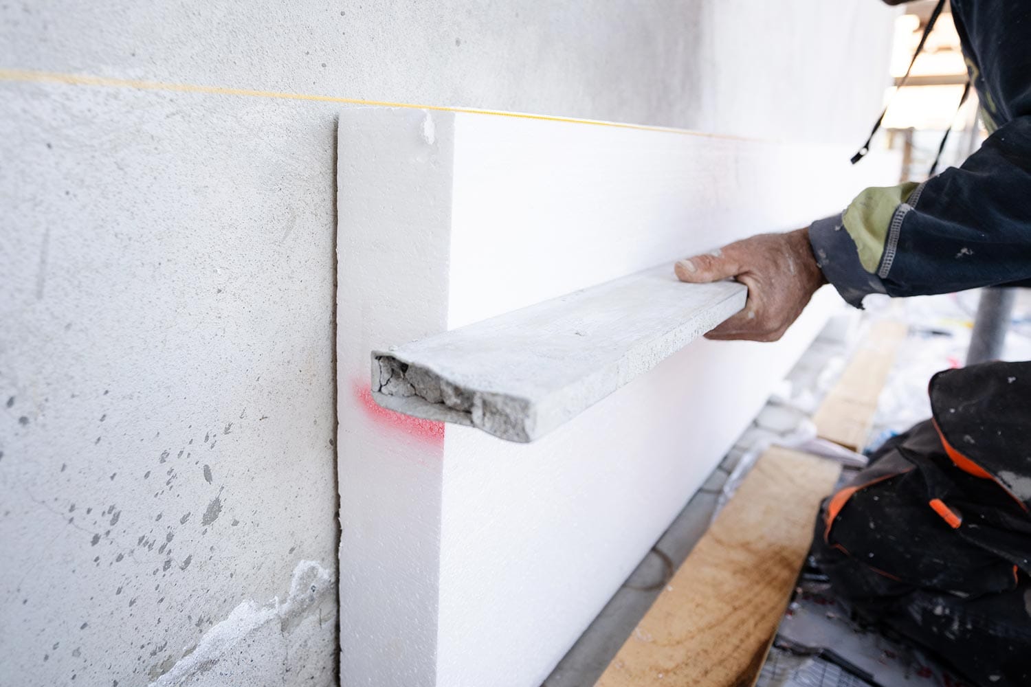 Construction worker during the Styrofoam house external wall insulation