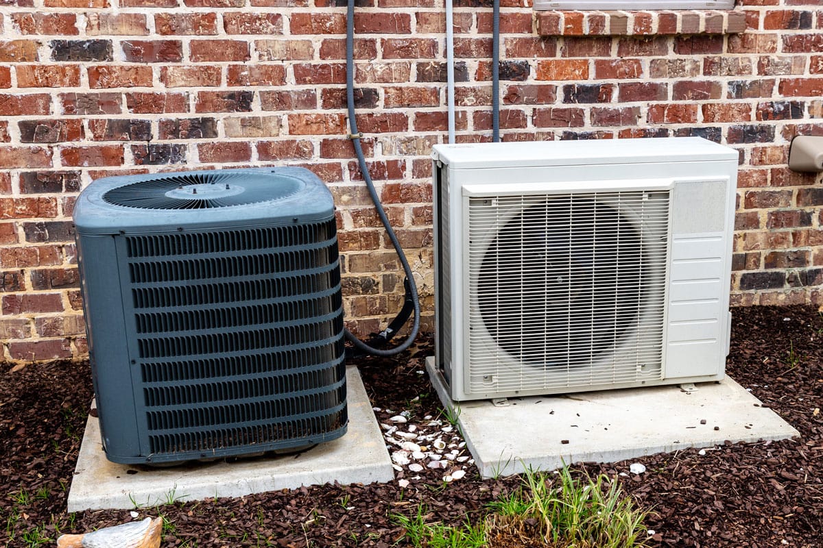 HVAC Air Conditioner Compressor and a Mini-split system together next to each other