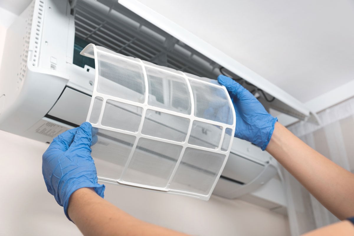 Modern air conditioner unit service Cleaning its filter