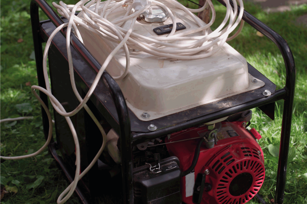 Portable power generator in a garden, summertime outdoor shot. What Size Generator Can Run A 5000 BTU Air Conditioner