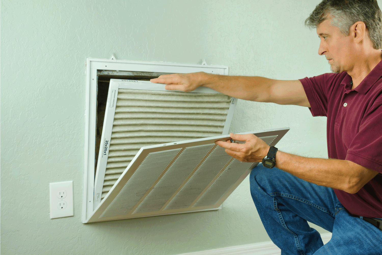 Professional repair service man or diy home owner removing a dirty air filter