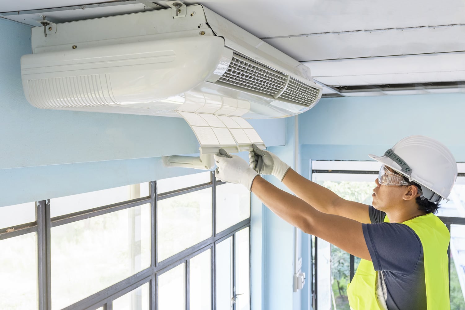 Technician do cleaning investigate Repairing Air Conditioner