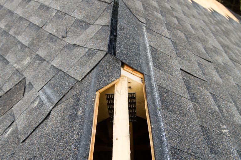 View of a partially shingled house roof, showing the cut-out for a ridge vent at the peak of the roof.Similar Images - Ridge Vents Don't Work—What To Do?