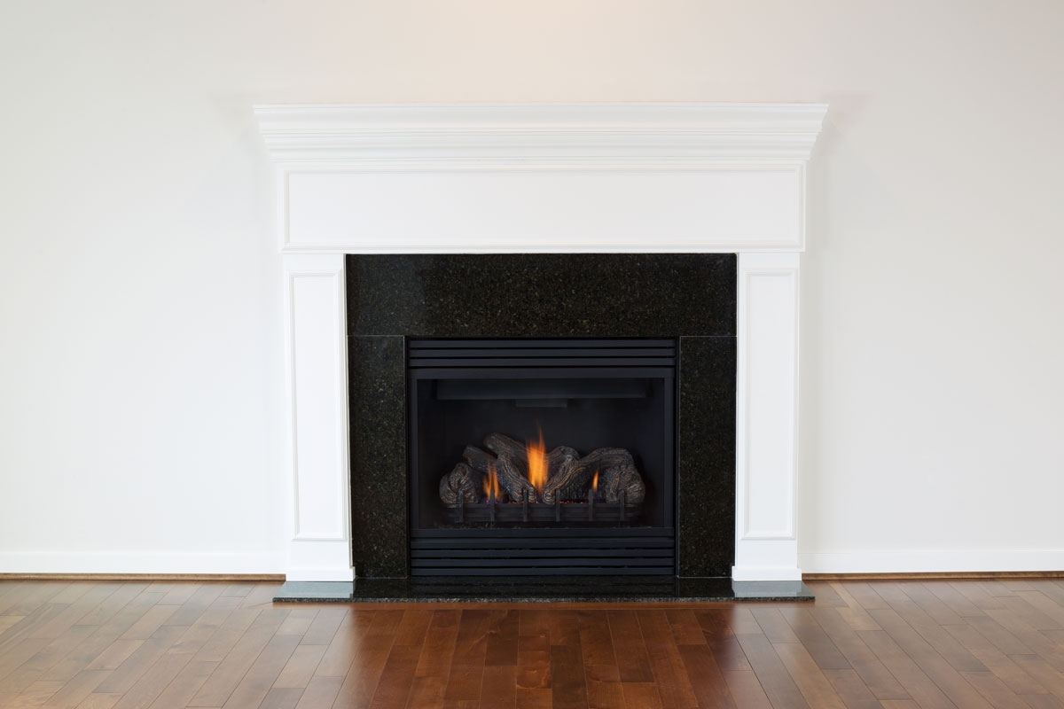 a natural gas fireplace with a white mantle