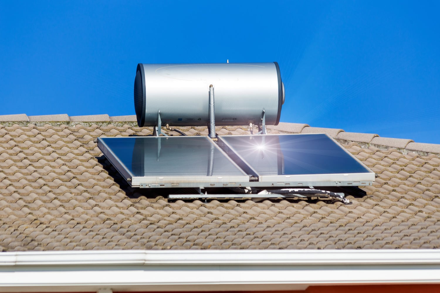 solar heater panels and sun beams on the roof alternative energy
