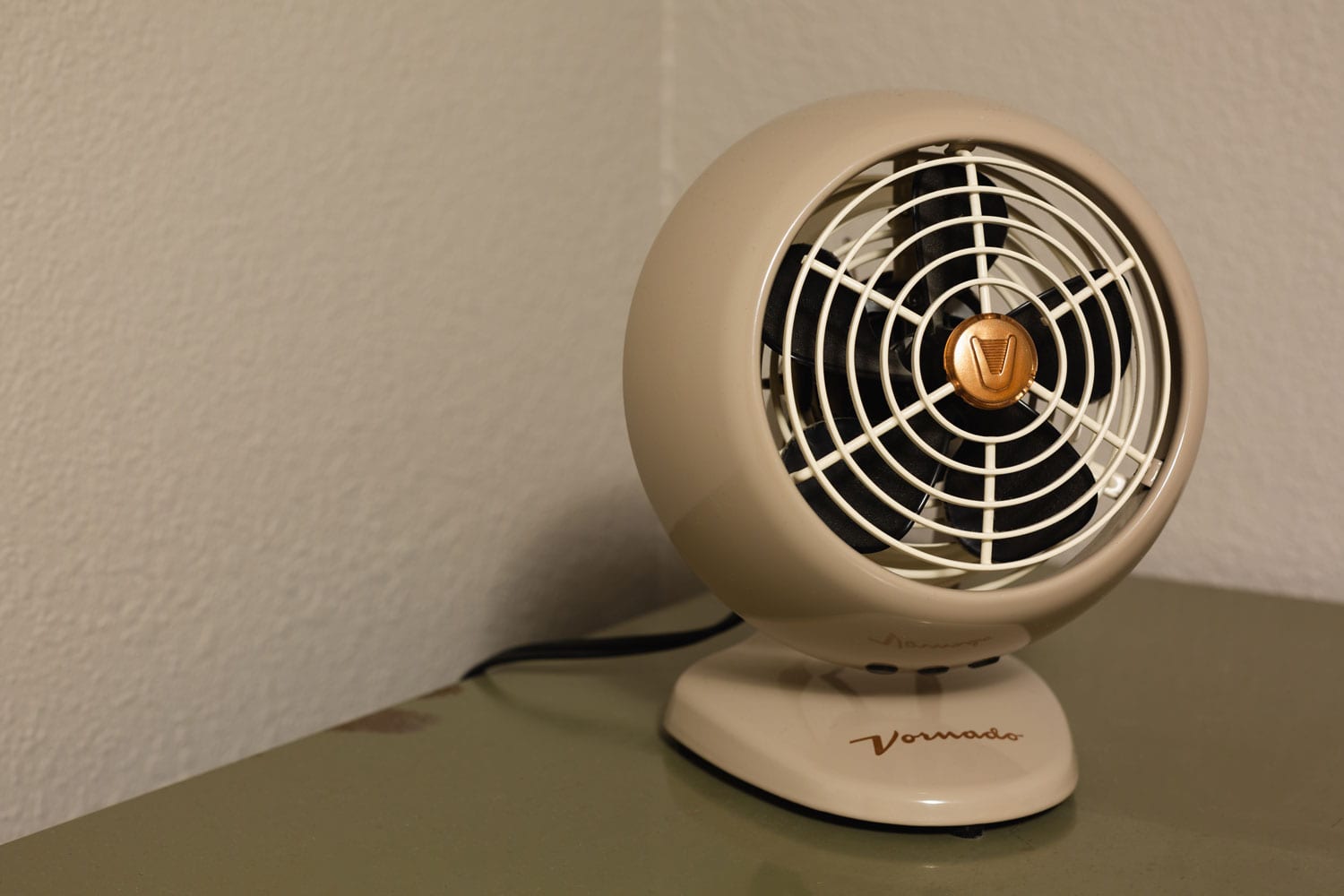 A beige colored Vornado fan at the table