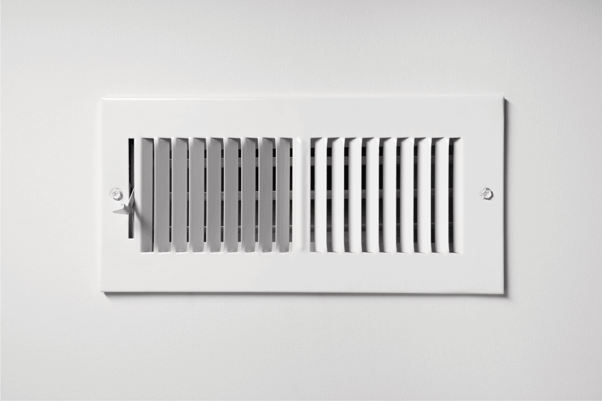 A cooling vent register on the wall of a home, with lever. How To Install a Return Air Duct In Your Ceiling