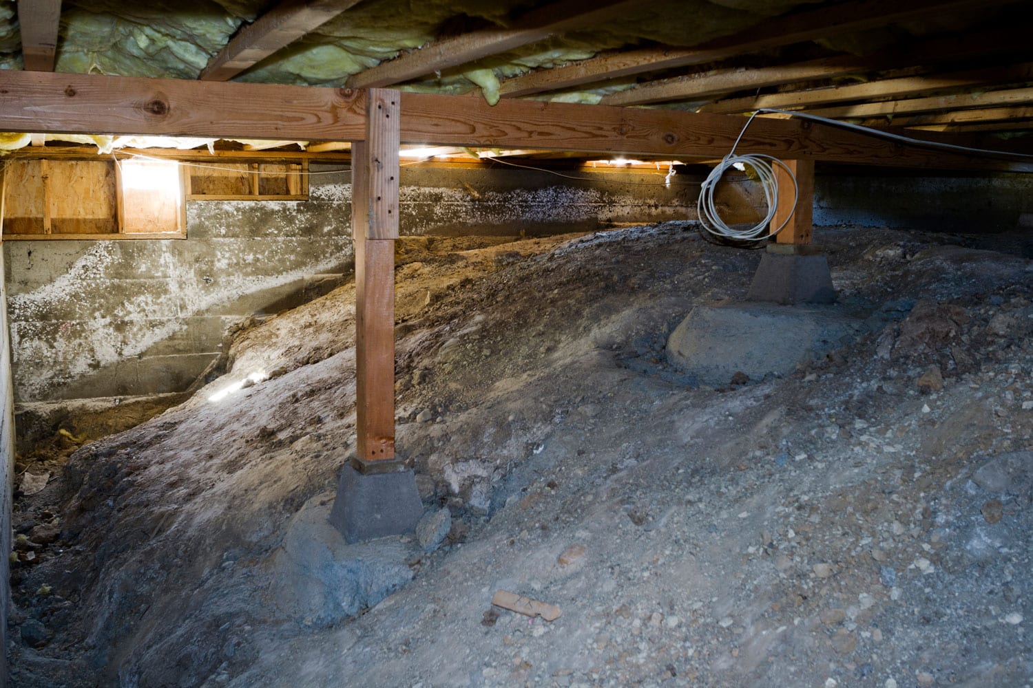 A crawlspace filled with soil
