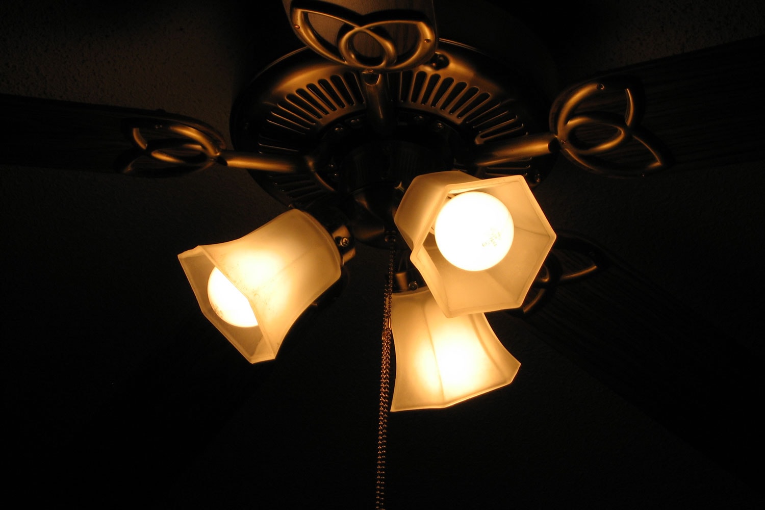 A geometric shaped ceiling fan with three hexagonal glass housed light bulbs