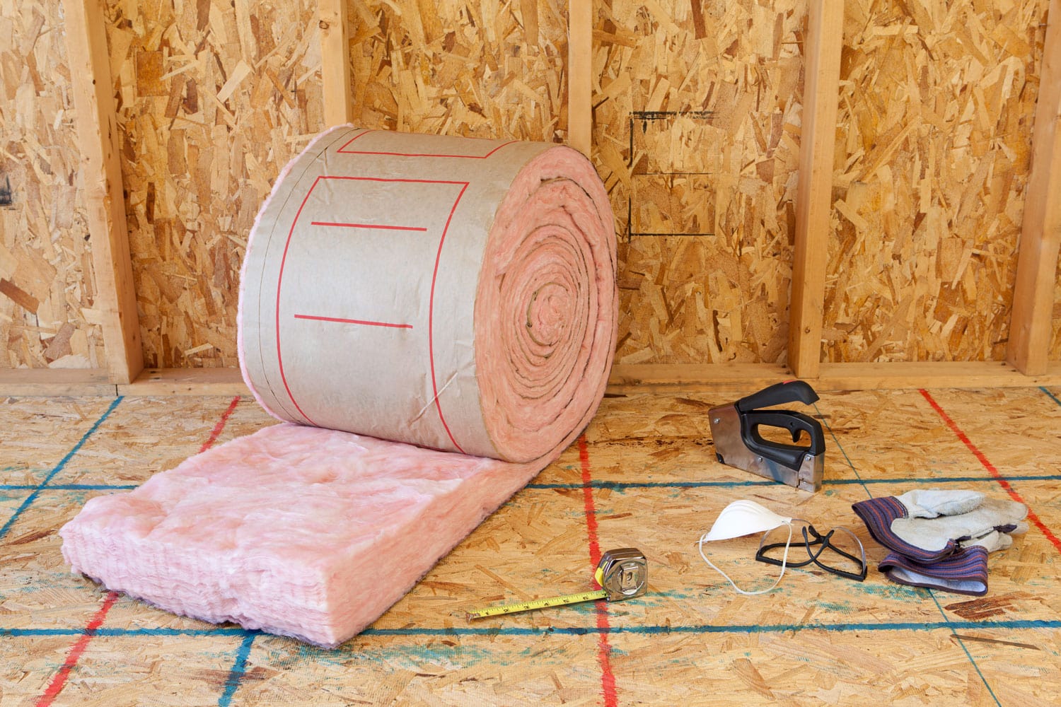 A huge roll of fiberglass insulation inside a room under construction