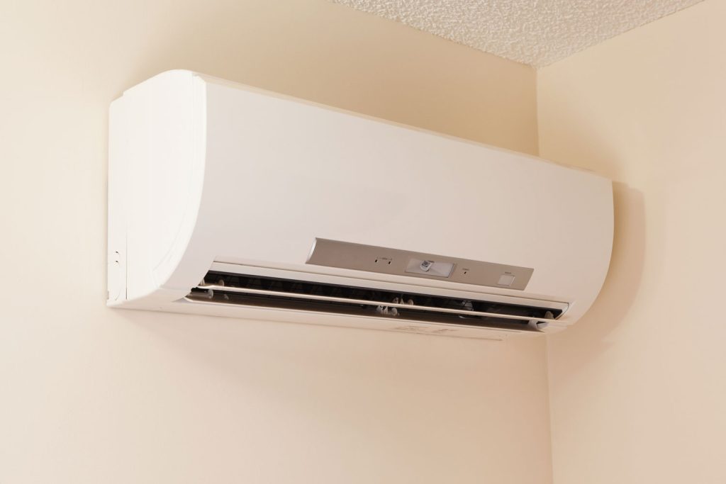 A wall-mount mini-split heating and air conditioning unit installed in a new house.