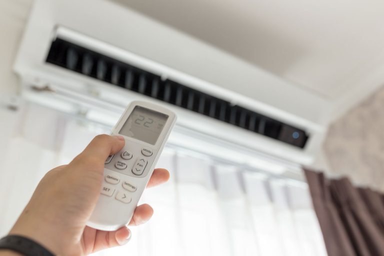 Air conditioner inside the room with woman operating remote controller,How To Connect GE Air Conditioner To Alexa Or Google Home?
