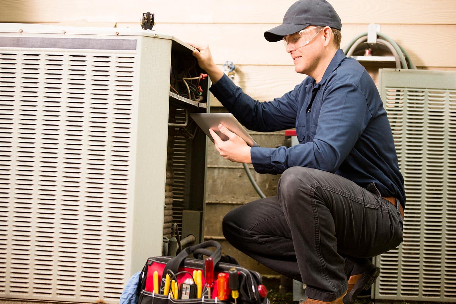 Air conditioner repairman works on home unit