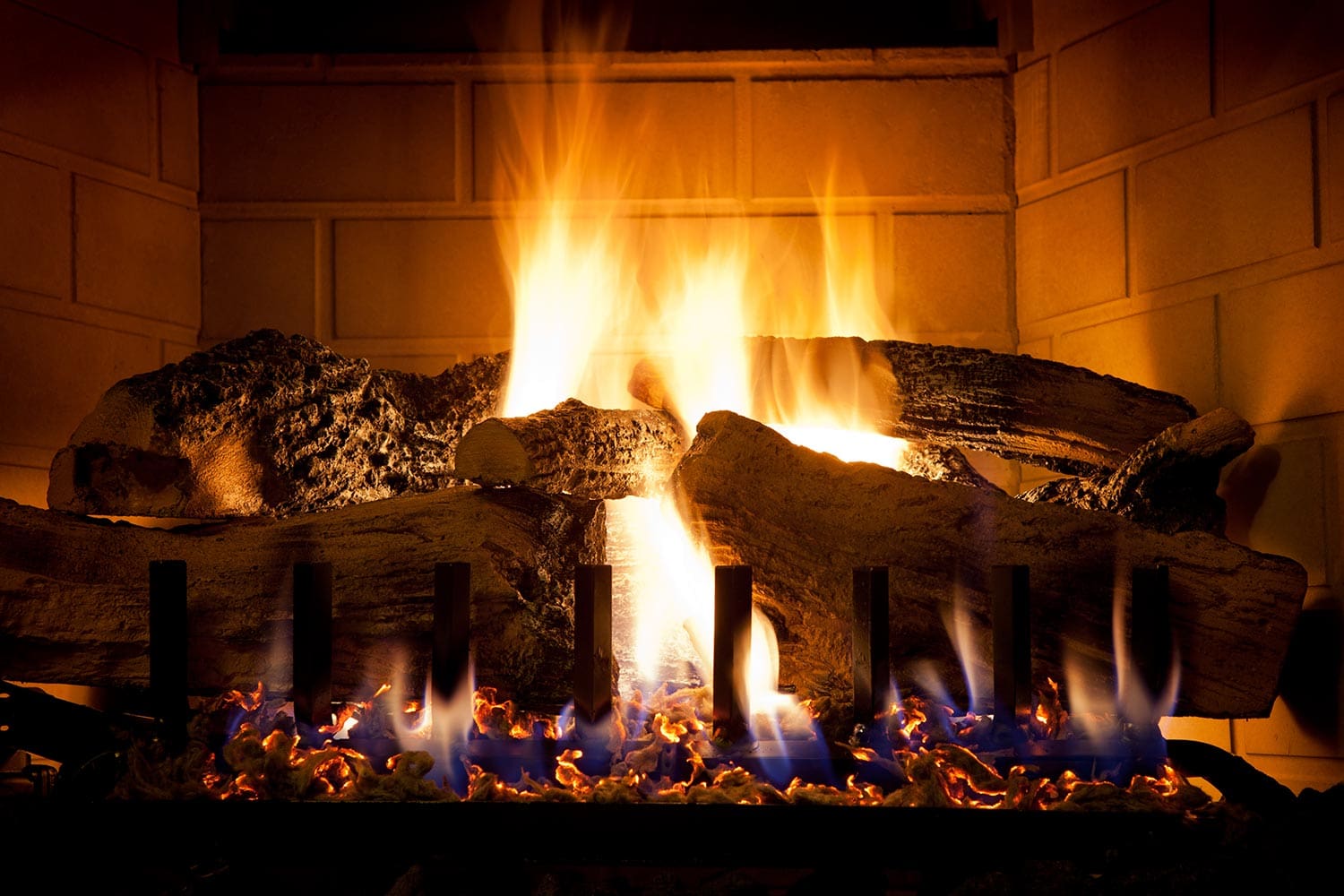 Burning logs and glowing embers in gas fireplace