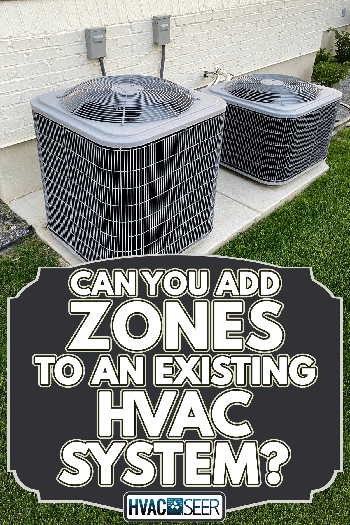 A double AC units outside white brick home with green landscape and gravel, Can You Add Zones To An Existing HVAC System?