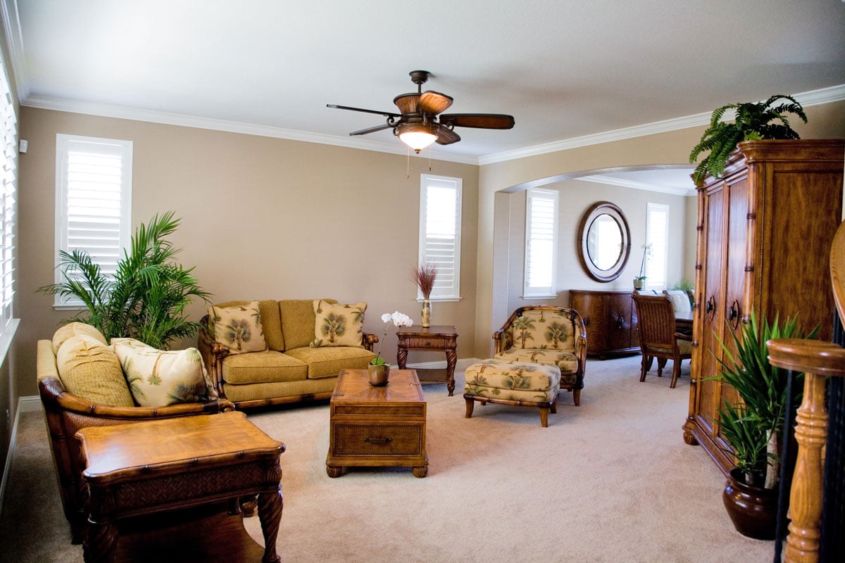 Classic living room with light color furnitures and brown ceiling fan