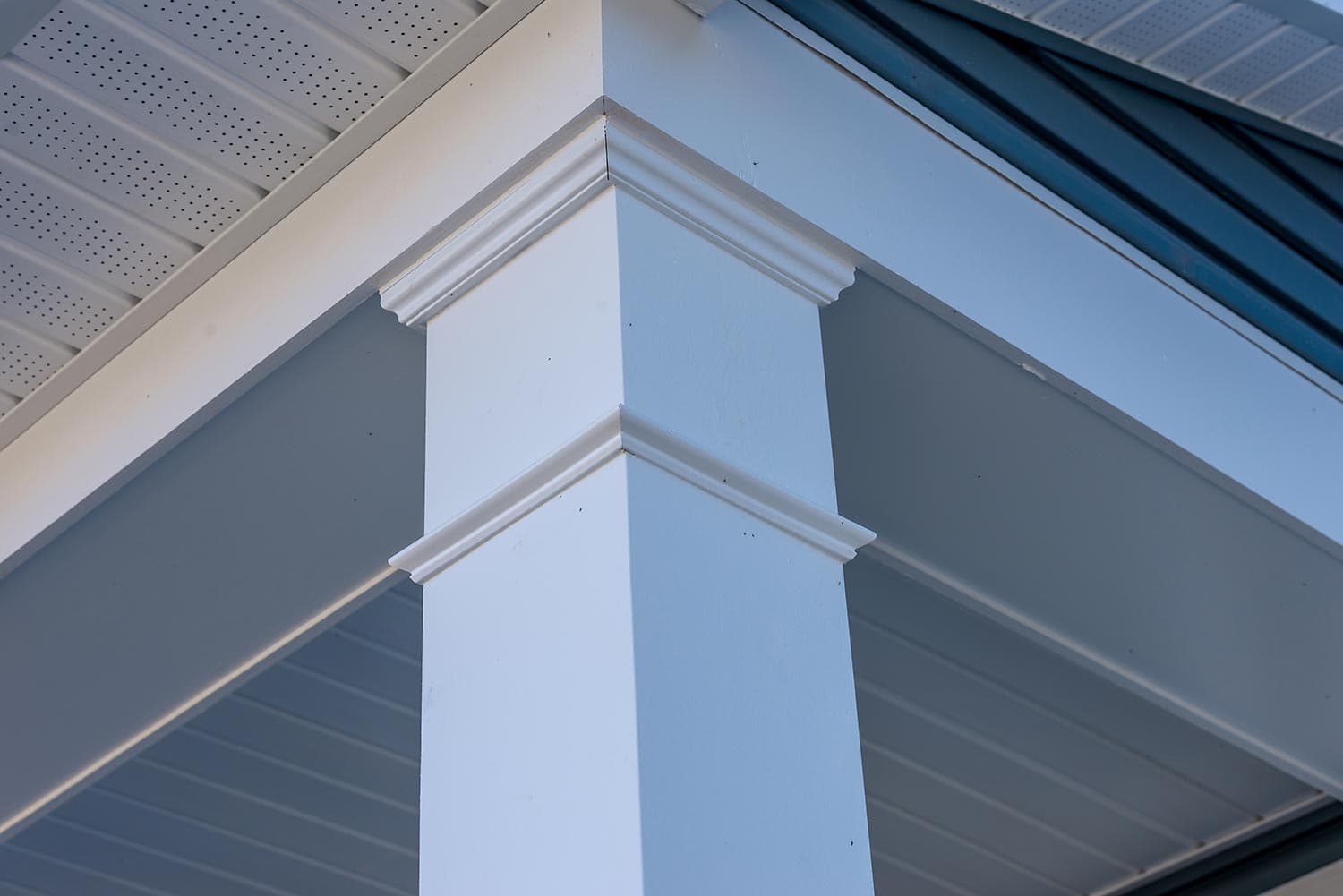 Colonial white custom porch columns with wood looking vinyl column wrap, sheets and molding, white soffit provides optimal ventilation for roof overhangs