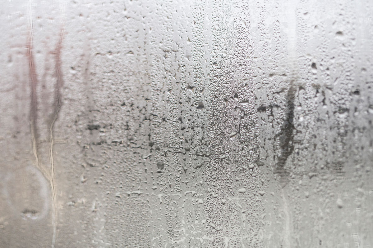 Condensation on window glass caused by high humidity in winter