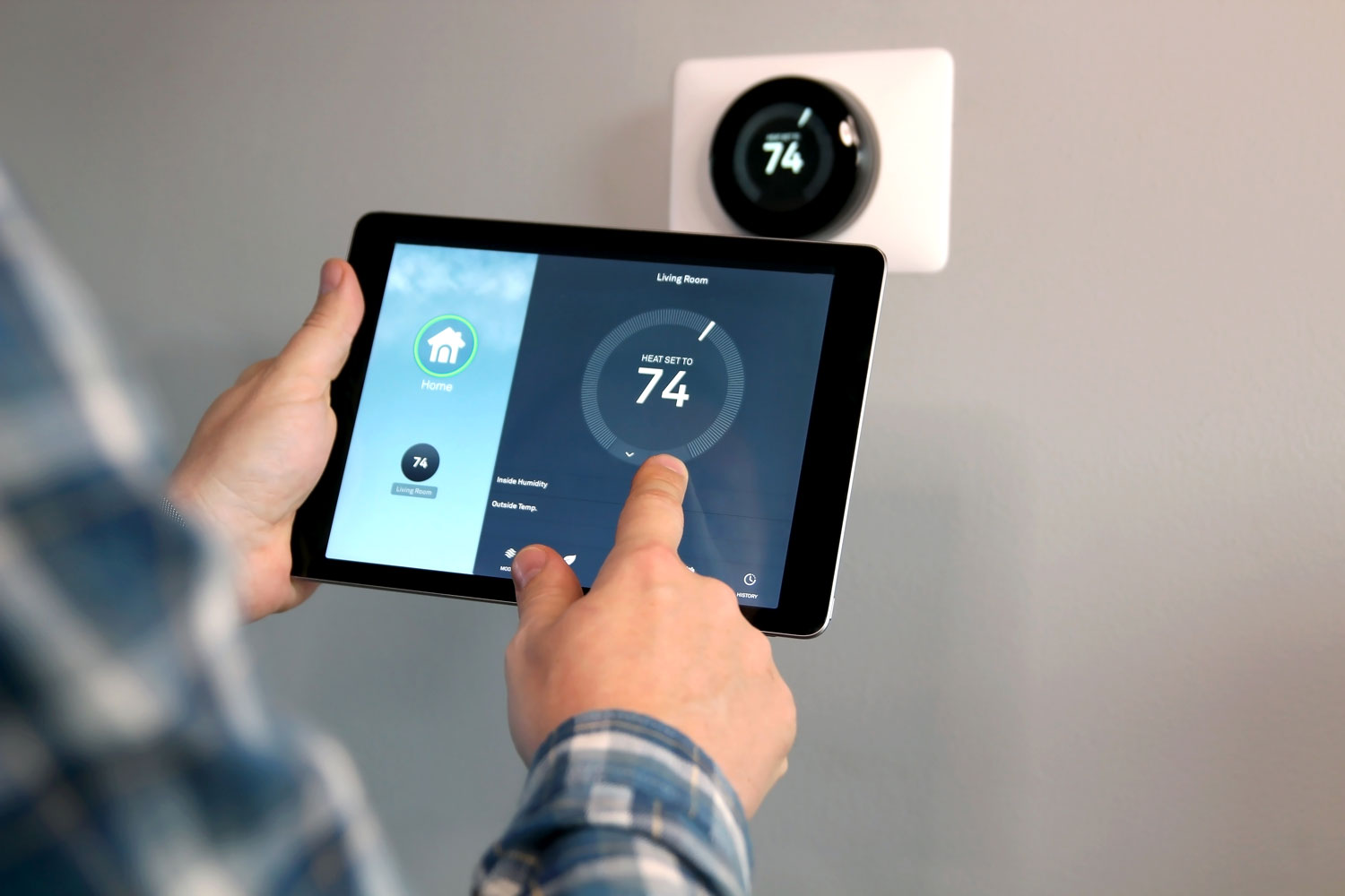 Homeowner changing the thermostat level using an iPad