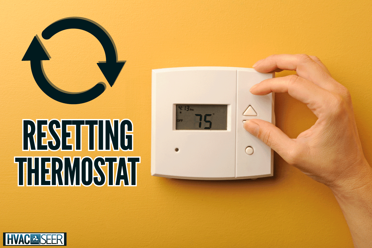 A woman turns down the thermostat, How To Reset Thermostat After Replacing Batteries