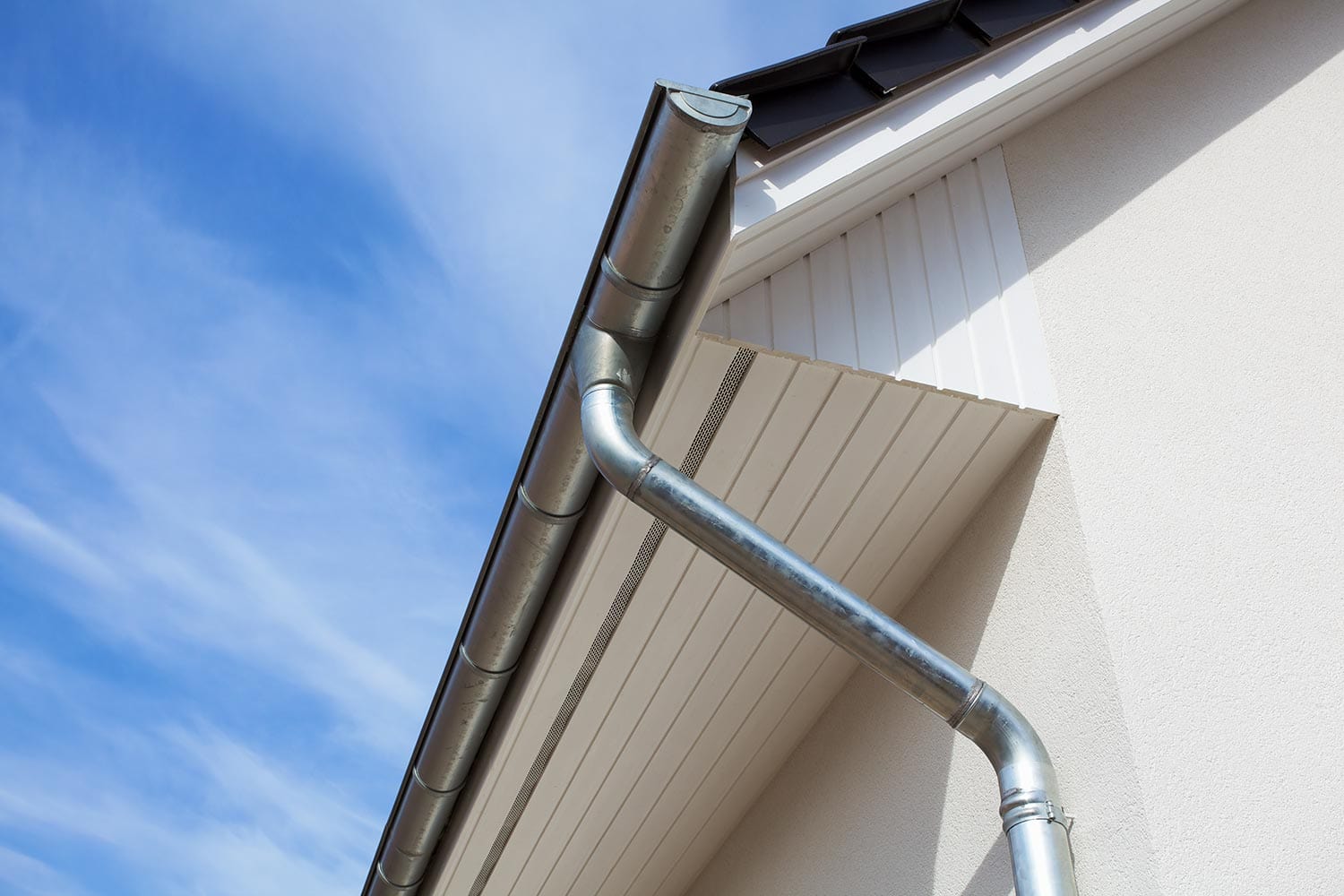 Metal rain gutter with downspout