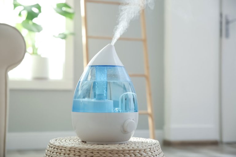 Modern Air Crane humidifier on wicker pouf indoor, Crane Humidifier Not Working - What's Wrong?
