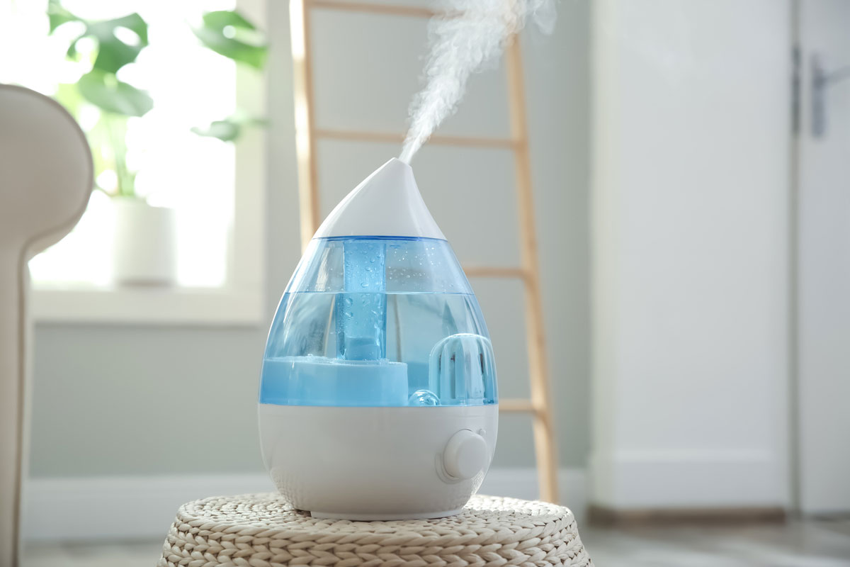 Modern Air Crane humidifier on wicker pouf indoor