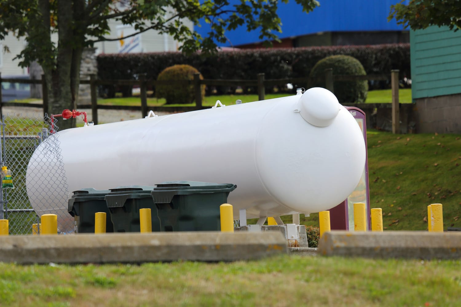 Propane tank with protective barriers around it.