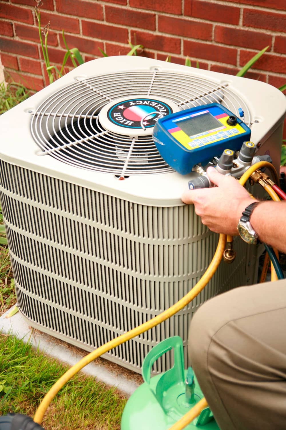 Technician refilling Freon of an air conditioning unit