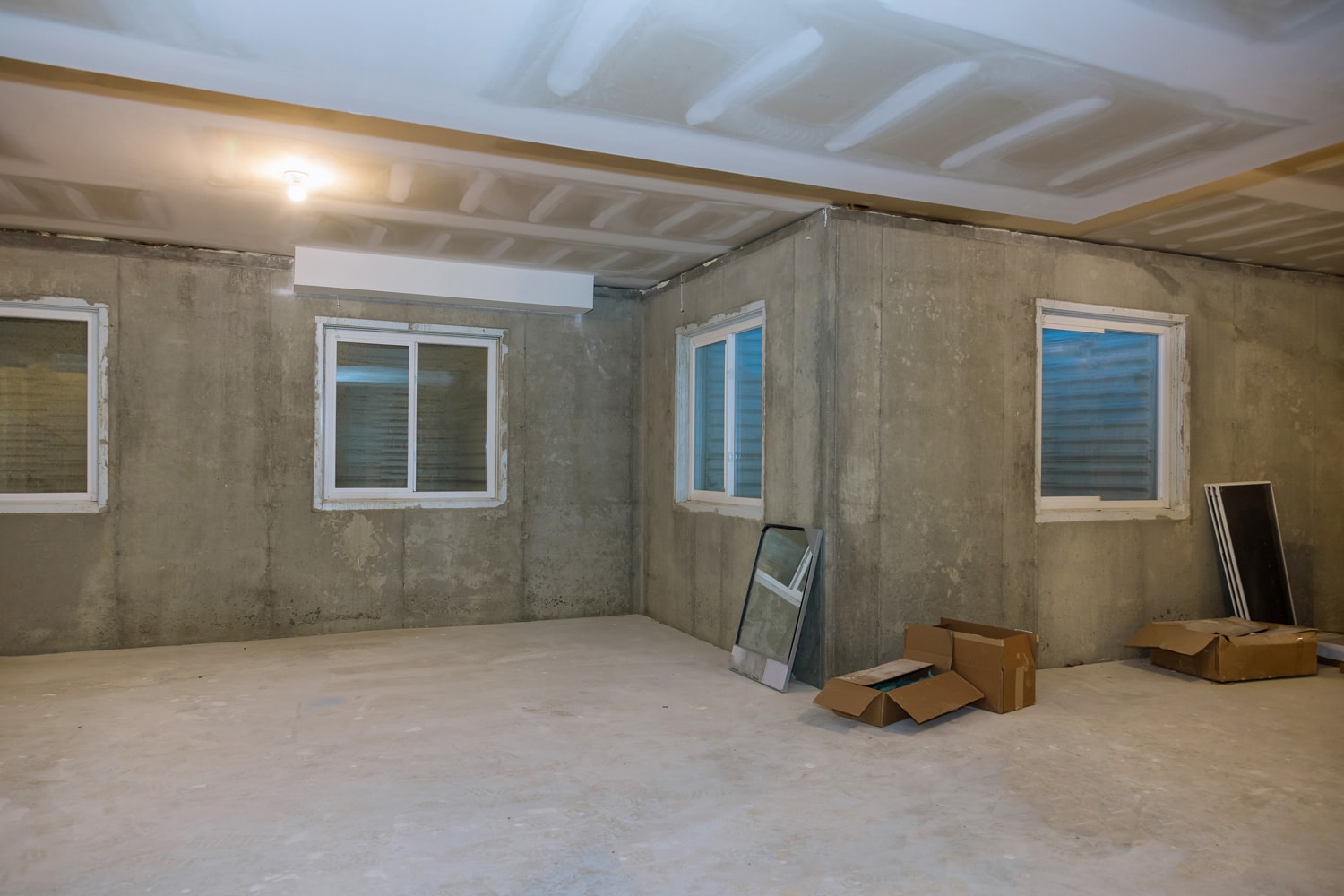 Unfinished view on concrete floor construction of basement empty under construction of residential home
