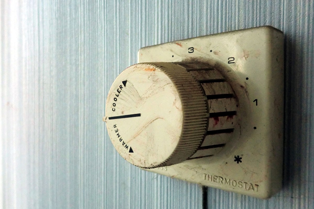 Vintage old grimy electrical thermostat controller dial