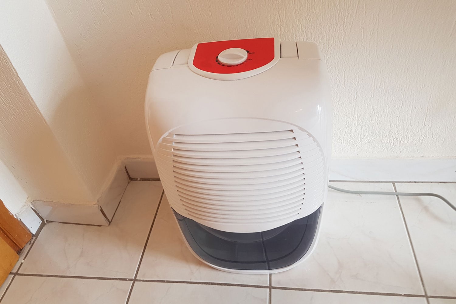 White portable AC in the corner of a room