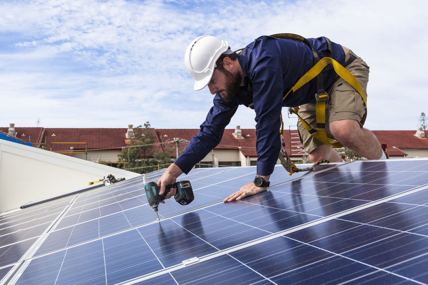 Worker installing a solar panel