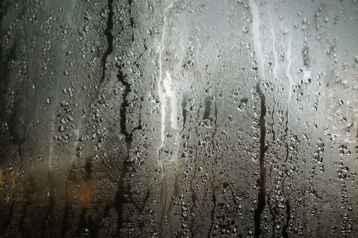 rain drops on glass texture abstraction people behind the glass