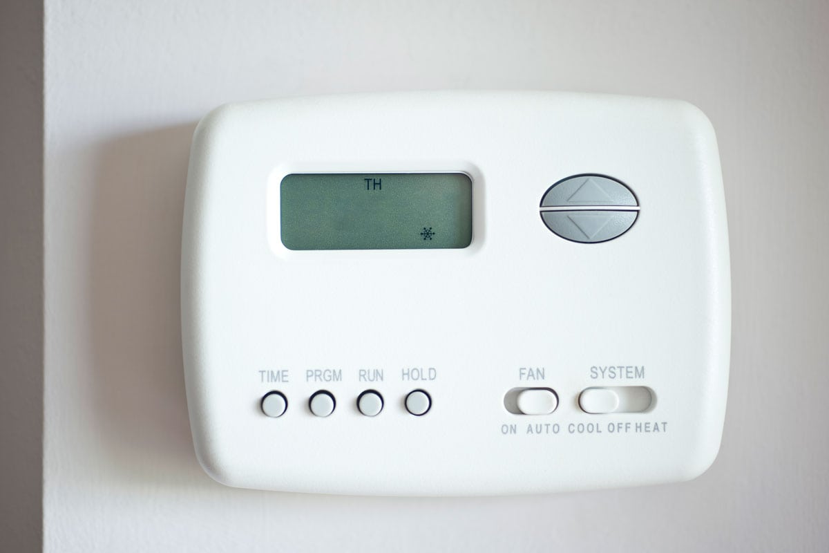 A Carrier thermostat mounted on the wall