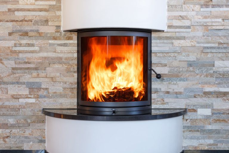 A glass covered circular fireplace, Fireplace Glass Turning Black - What To Do?