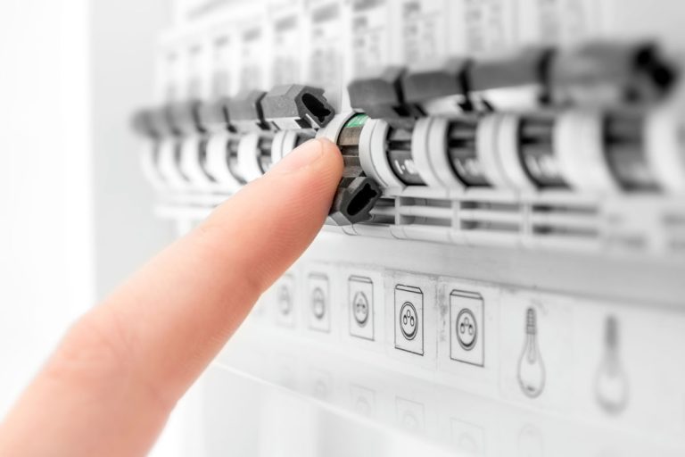 A human hand is cutting out, turning OFF a circuit breaker fuse box switch, What Size Breaker For 8 kW Heat Strip?