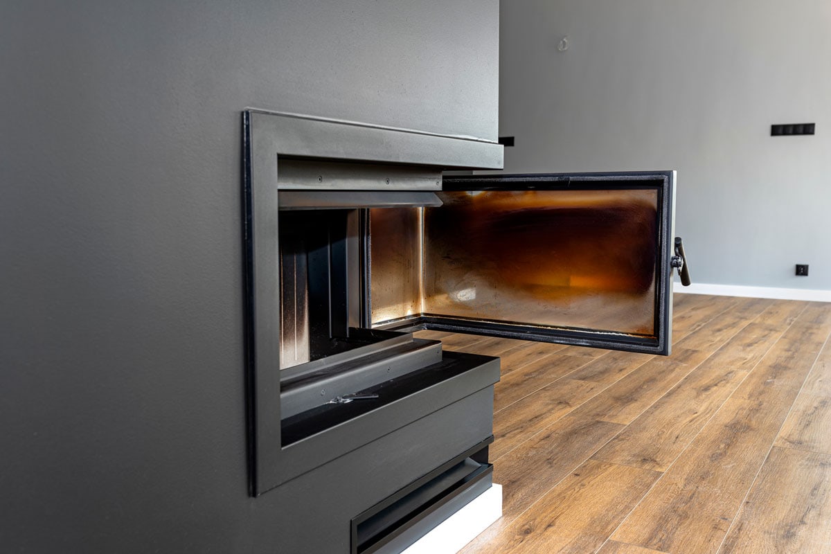 A tall black glass covered fireplace