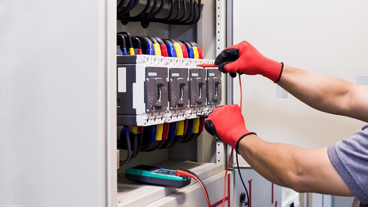 An electrical engineer inspects the plant's electrical control equipment