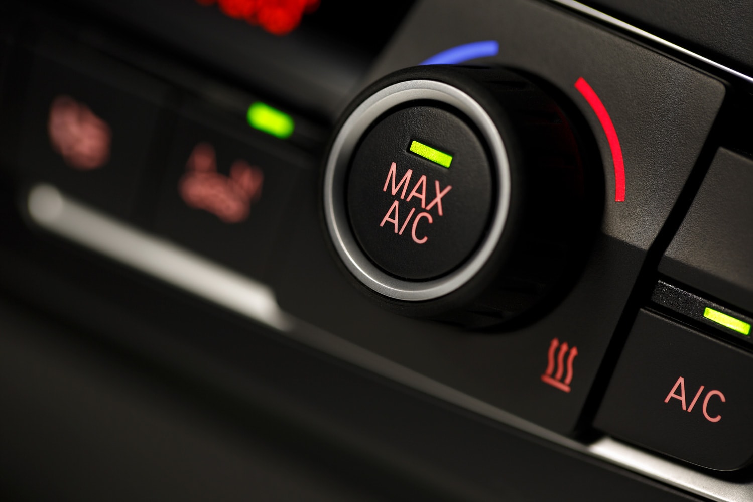 Color detail with the air conditioning button inside a car, shot with very shallow depth of field
