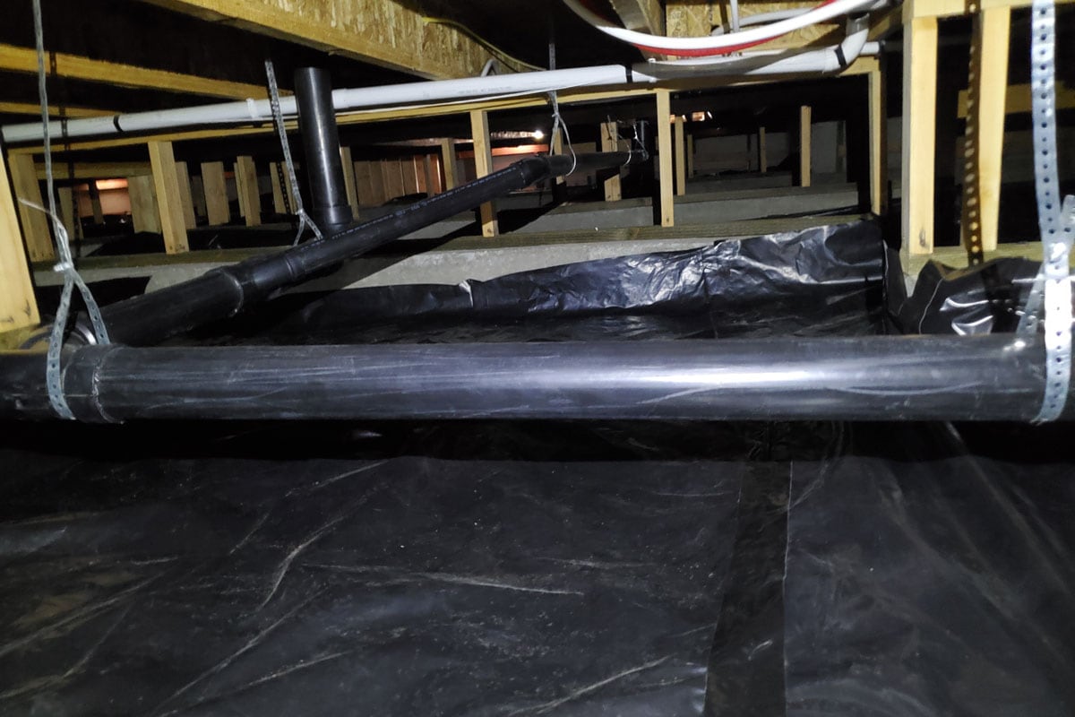 Crawlspace under a residential building with new vapor barrier