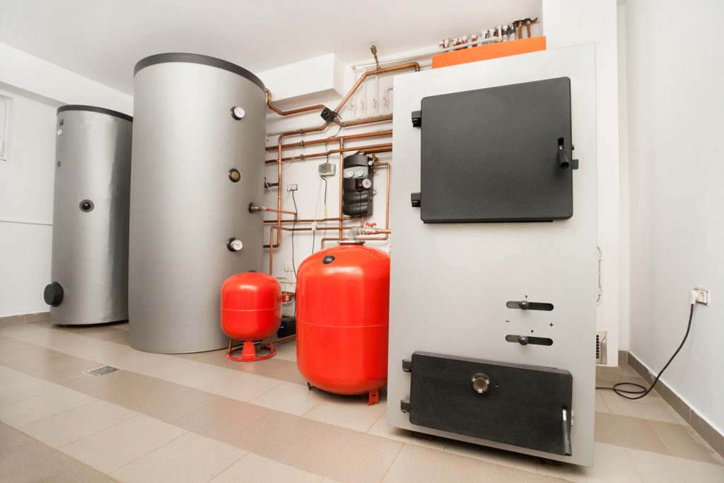 Energy Saving Appliances At home. Boilers And Pressure Tanks Part Of a Domestic Water Heating system. This is a hybrid system, solar and solid fuel.