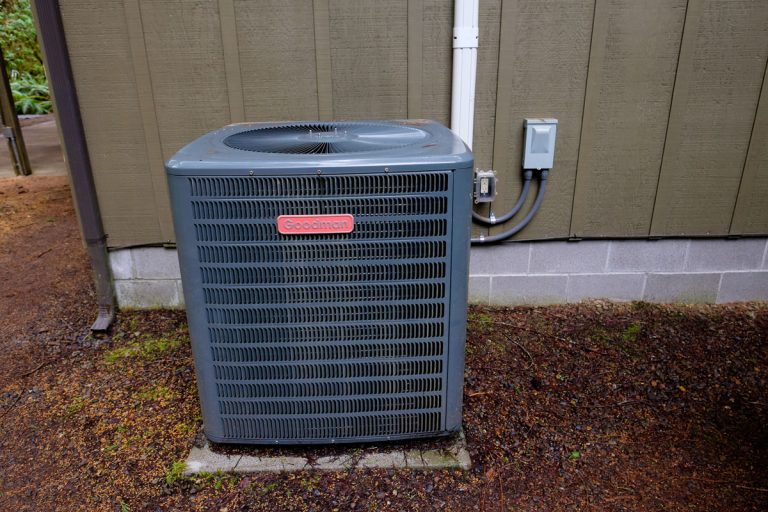 Goodman HVAC unit on the outside of a vacation house, Goodman AC Vs Rheem: Which To Choose?