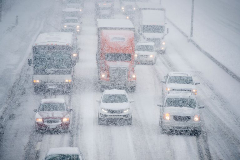 Heavy traffic caused by snow storm, Should You Run Your Car AC In Winter?