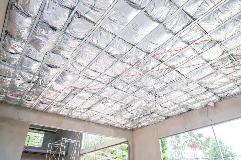 Home under construction install heat insulate ceiling in the form of foil. - How To Install Roof Insulation Foil