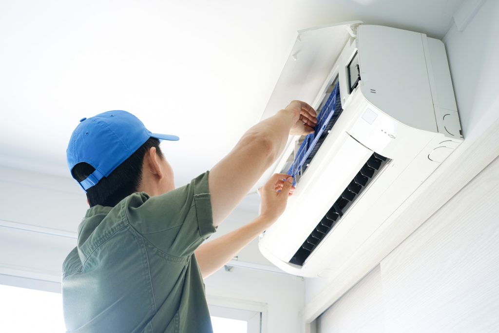 Male repair air conditioner at room