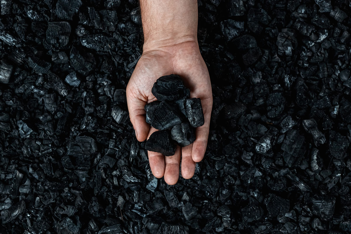 Man holding coal