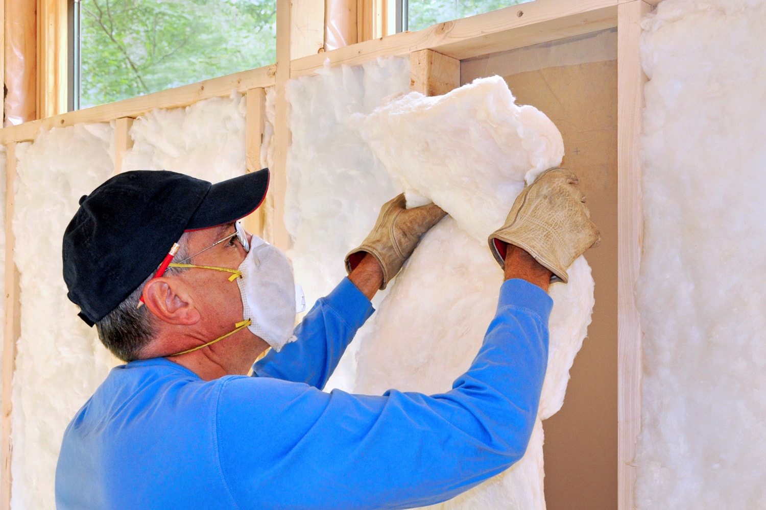 Man removing fiberglass insulation