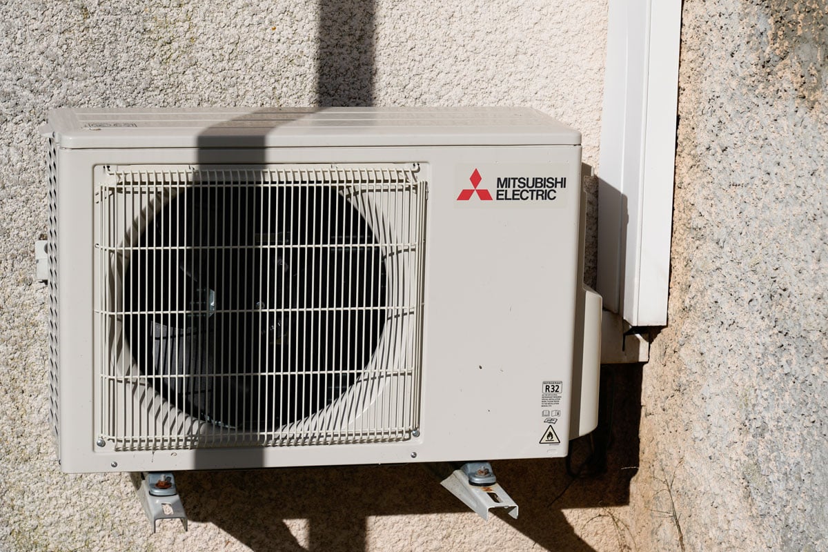 Mitsubishi air conditioning unit mounted on metal brackets, How To Clean Mitsubishi Air Conditioner [Inc. Outside Unit]