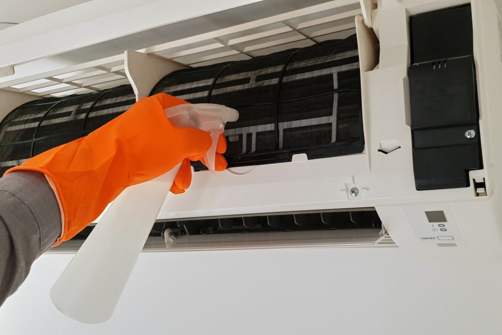 Modern airconditioner unit service cleaning the filter to prevent respiratory disease. 
